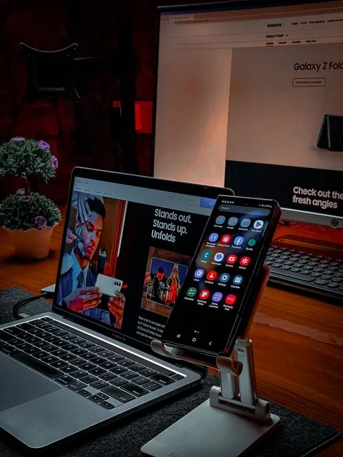 A modern workspace featuring dual computer monitors displaying web design projects, emphasizing technology and productivity.