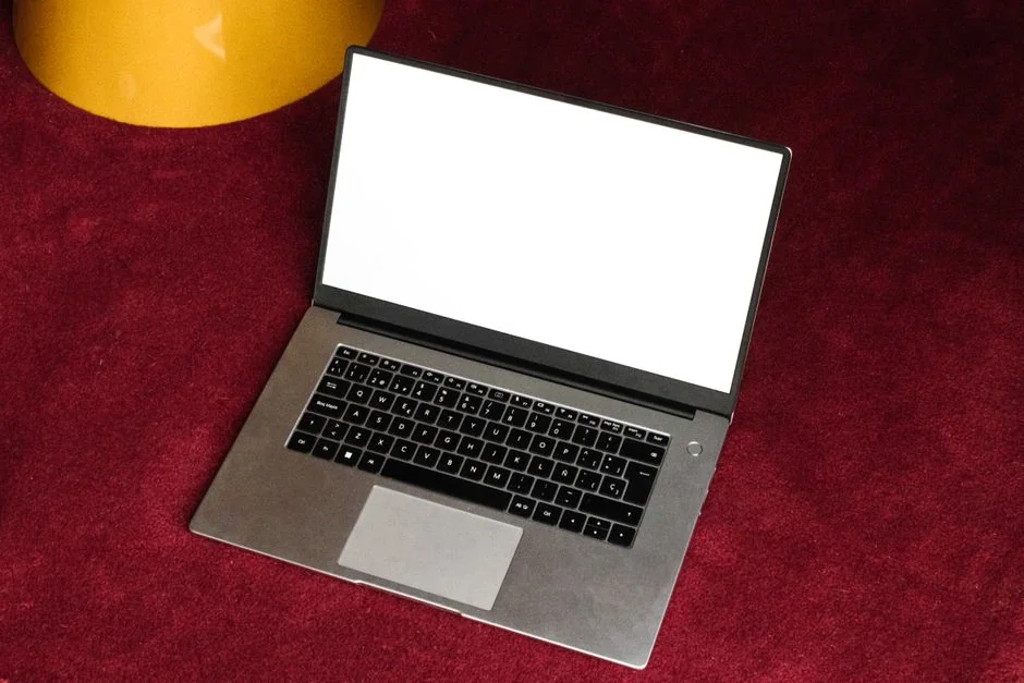 A minimalist desk setup featuring dual monitors, keyboard, mouse, and notebook for productivity.